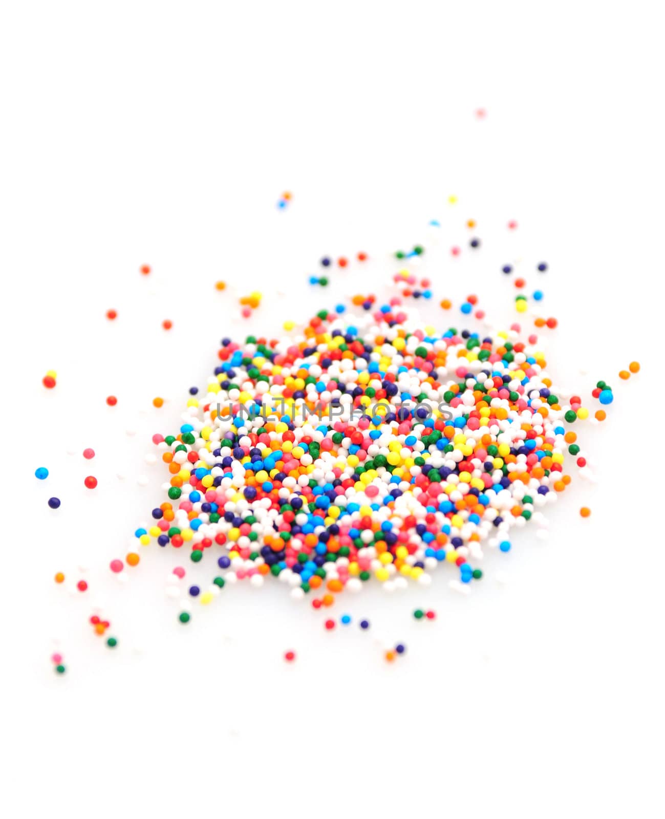 Colorful sprinkles on white background by ftlaudgirl