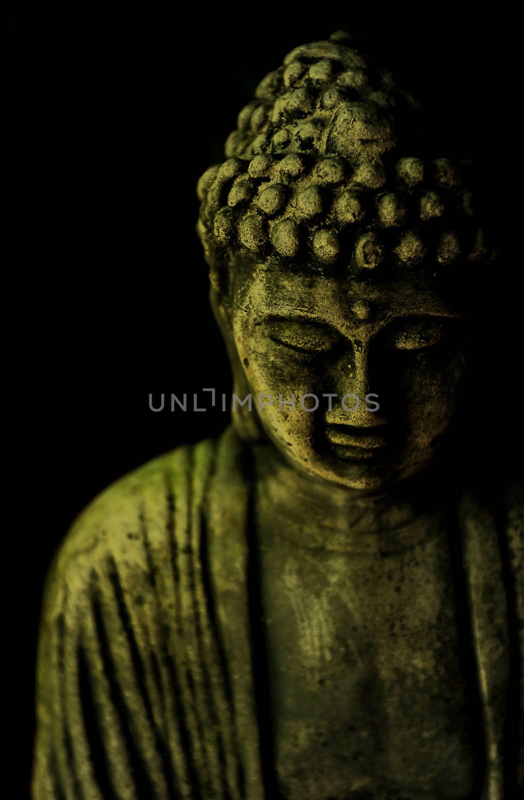 A Buddha statue on a black background