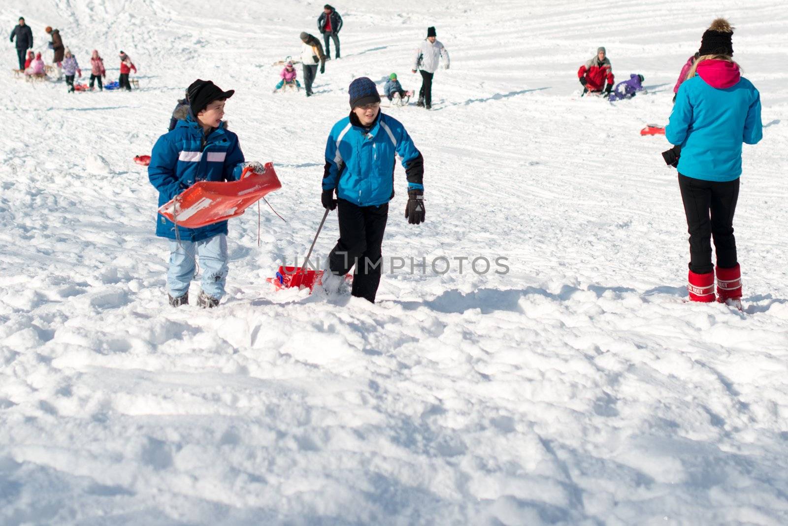 Stuttgart, Germany – February 9, 2013: Kids and families having fun with their sledges, bright and white winter scene on February 9, 2013 on the hills of Feuerbacher Heide in Stuttgart, Germany.