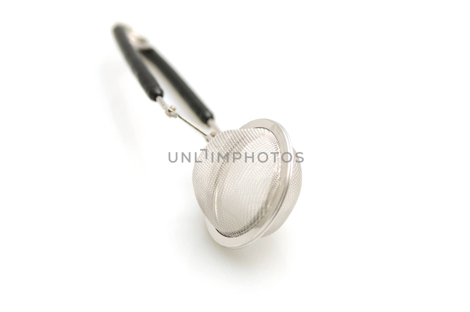 close up of tea strainer on white background