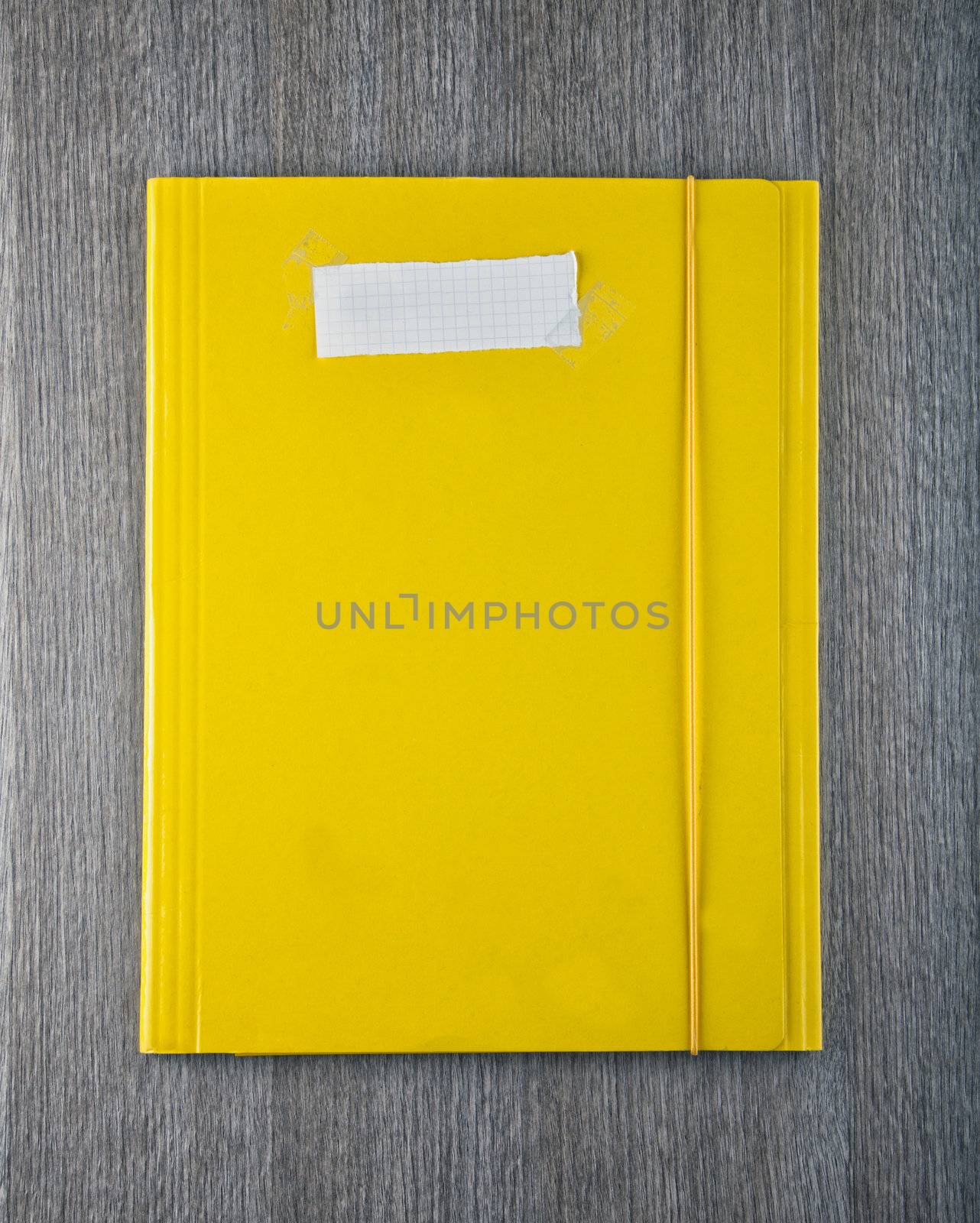 A yellow folder with empty white paper label