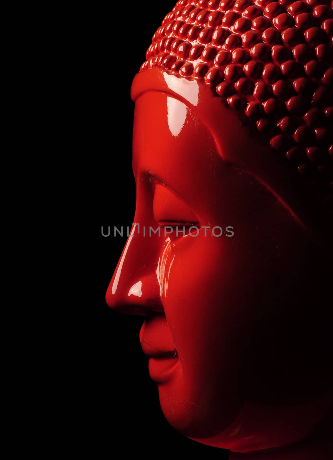 Orange buddha head on black background