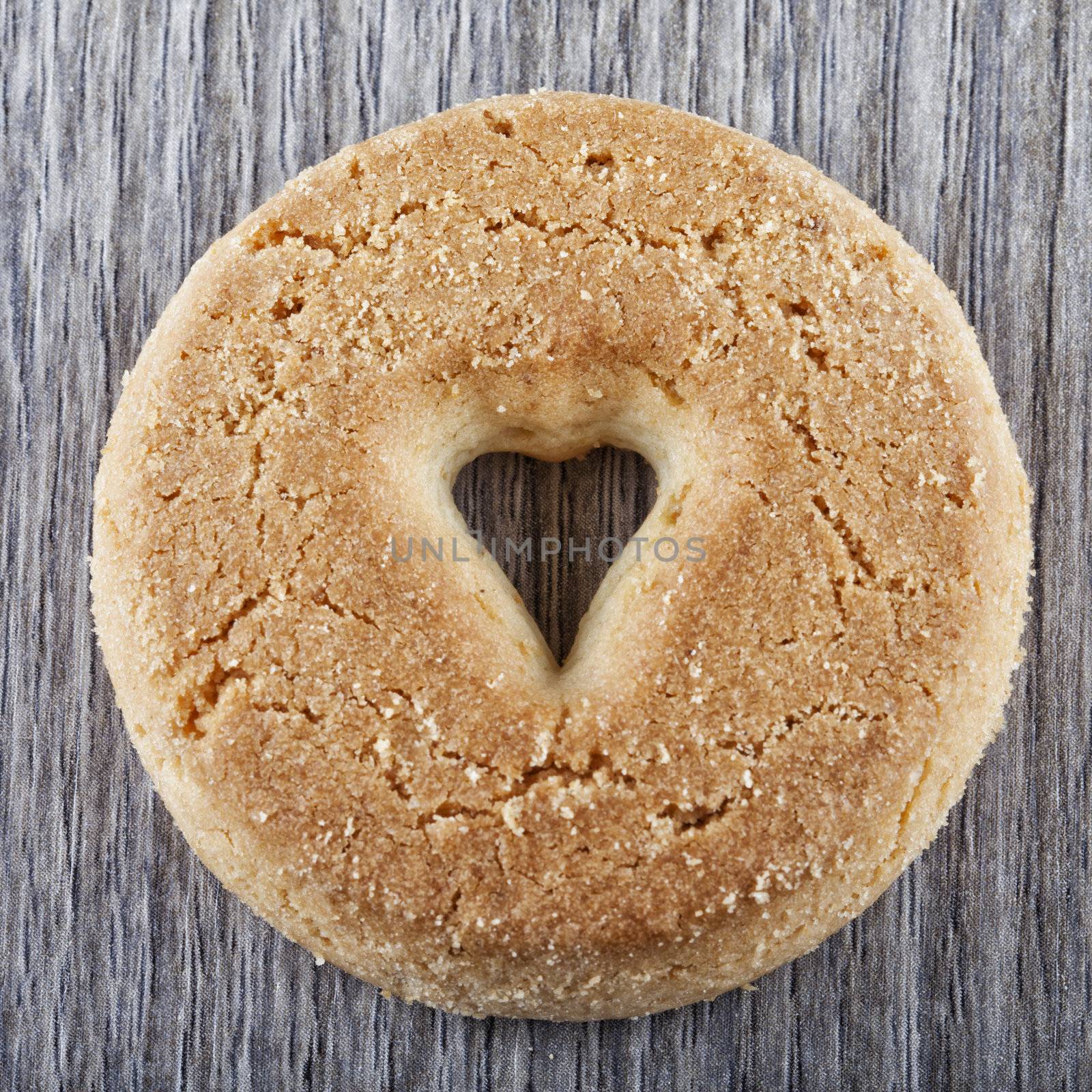 A biscuit with a hole in shape of heart in the center