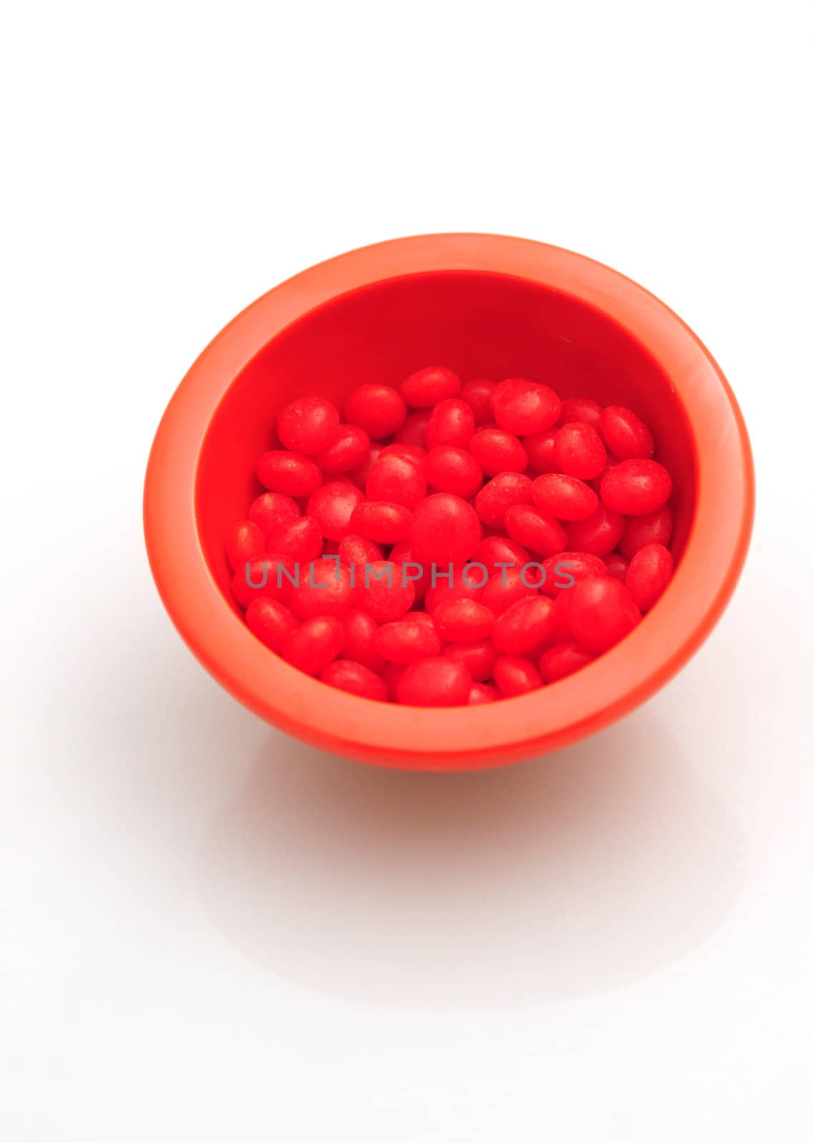 red hots candy in a bowl isolated on a white background