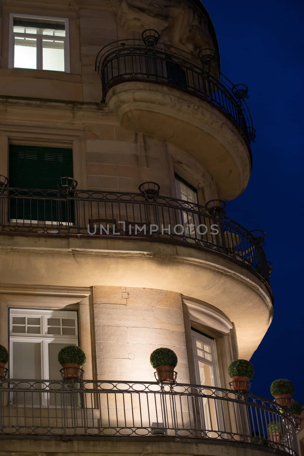 Facade of a beautiful old building with balconies and plastic flowers in the evening in Heidelberg, Germany