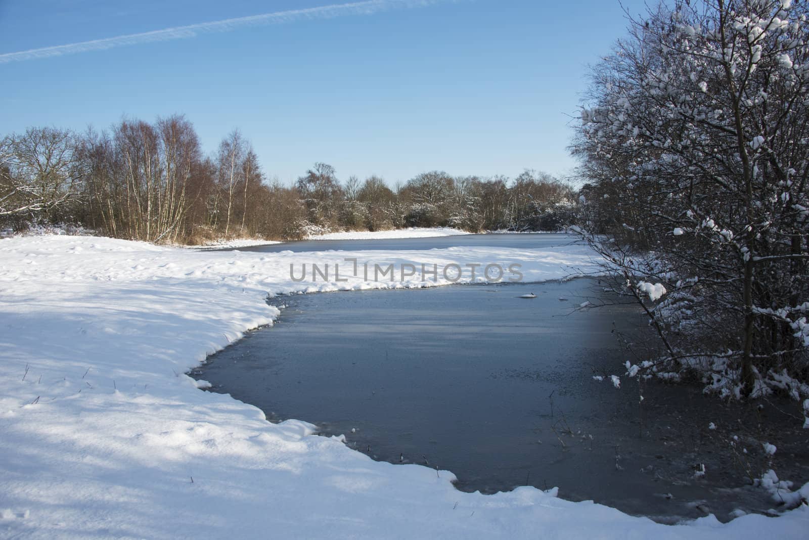 ice on the water in winter landscape with white snow