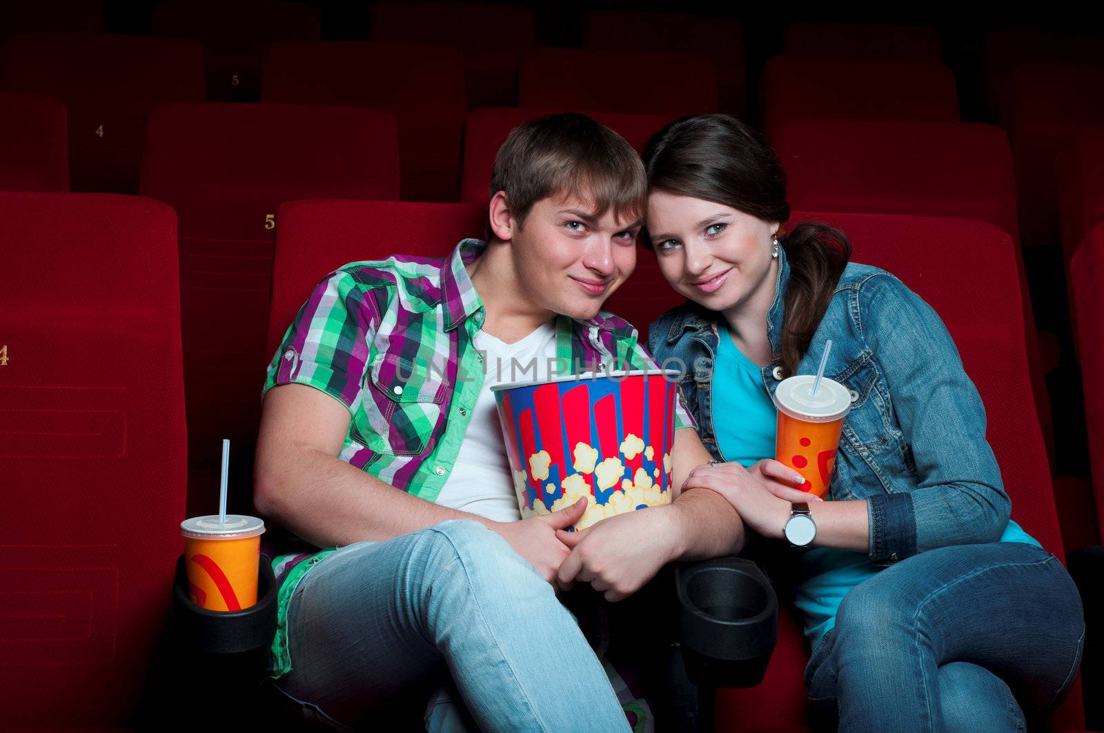 couple in a movie theater, watching a movie