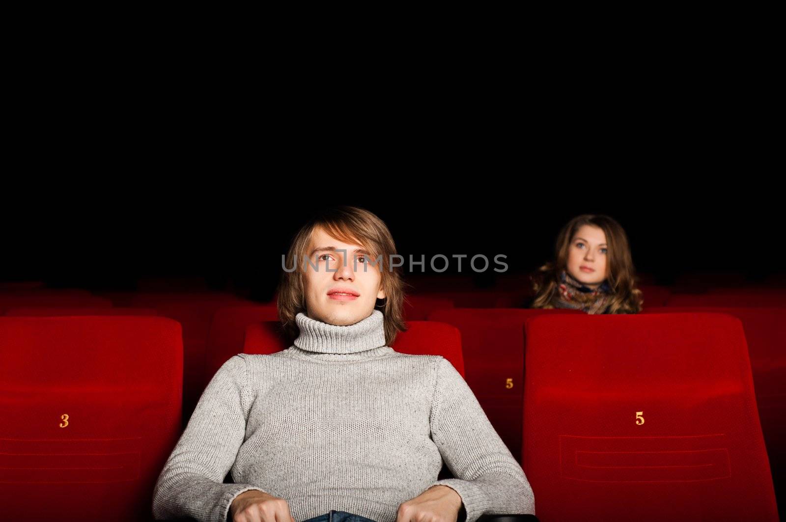 young man and woman in the cinema to enjoy the movie