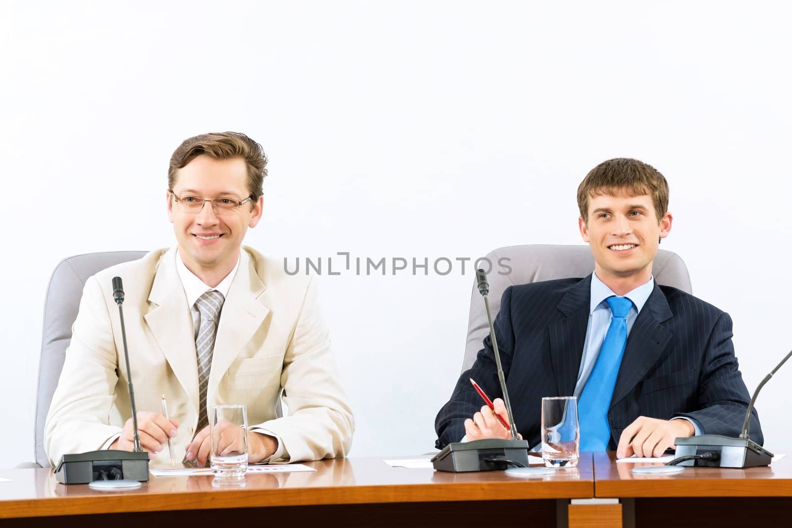 two businessmen sitting in a chair at the table, talk at the conference