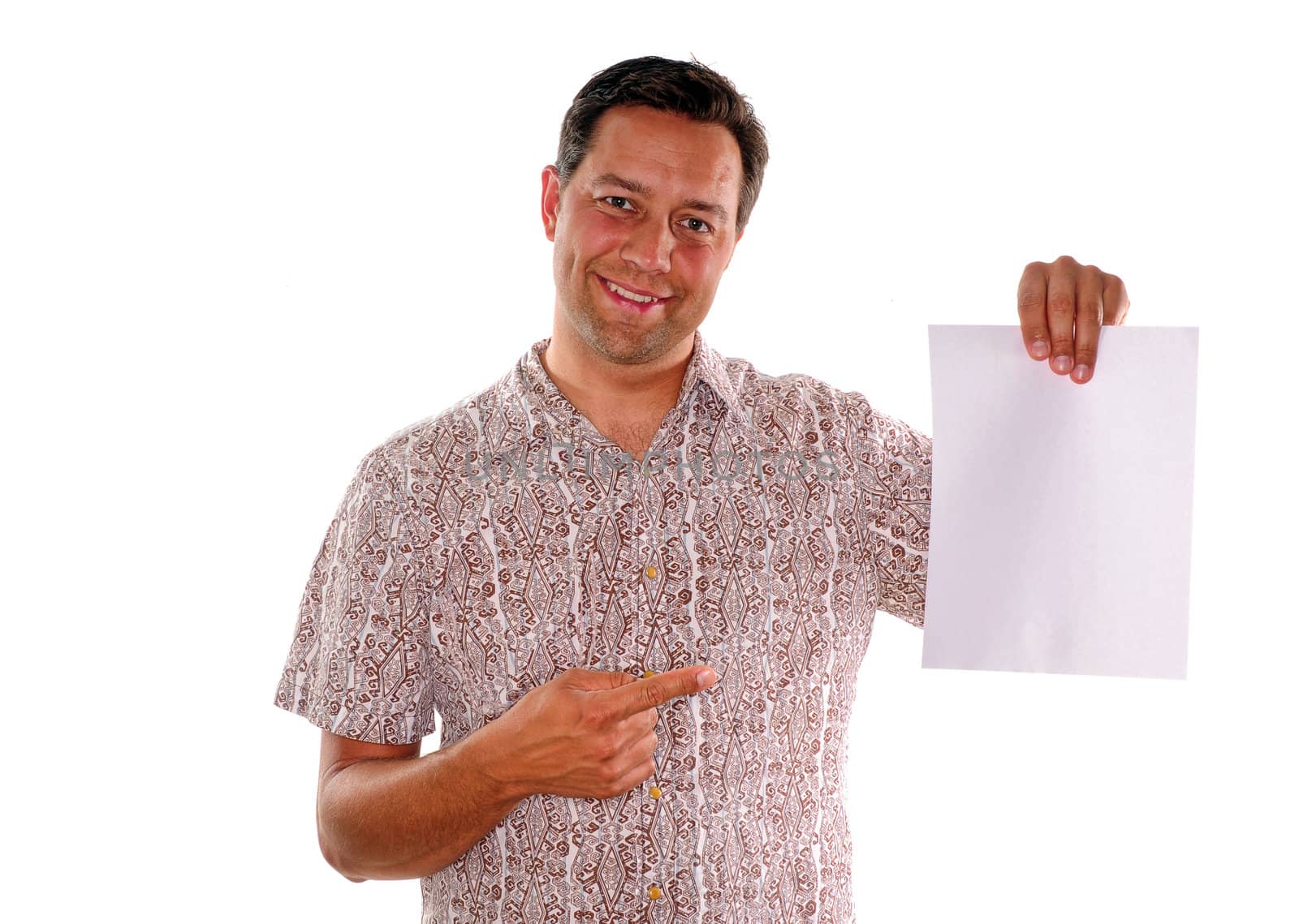 Young man pointing to portrait style blank piece of paper for advertisement