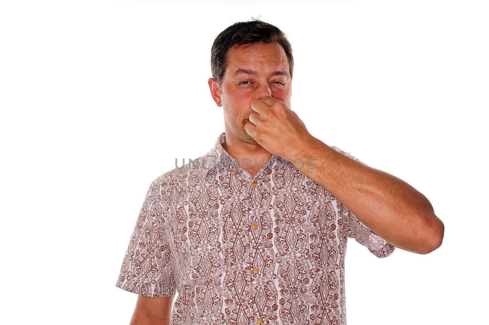Man plugging nose after smelling a very bad stench