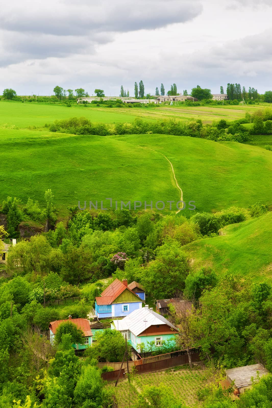 landscape with farm and green meadow, high angle view