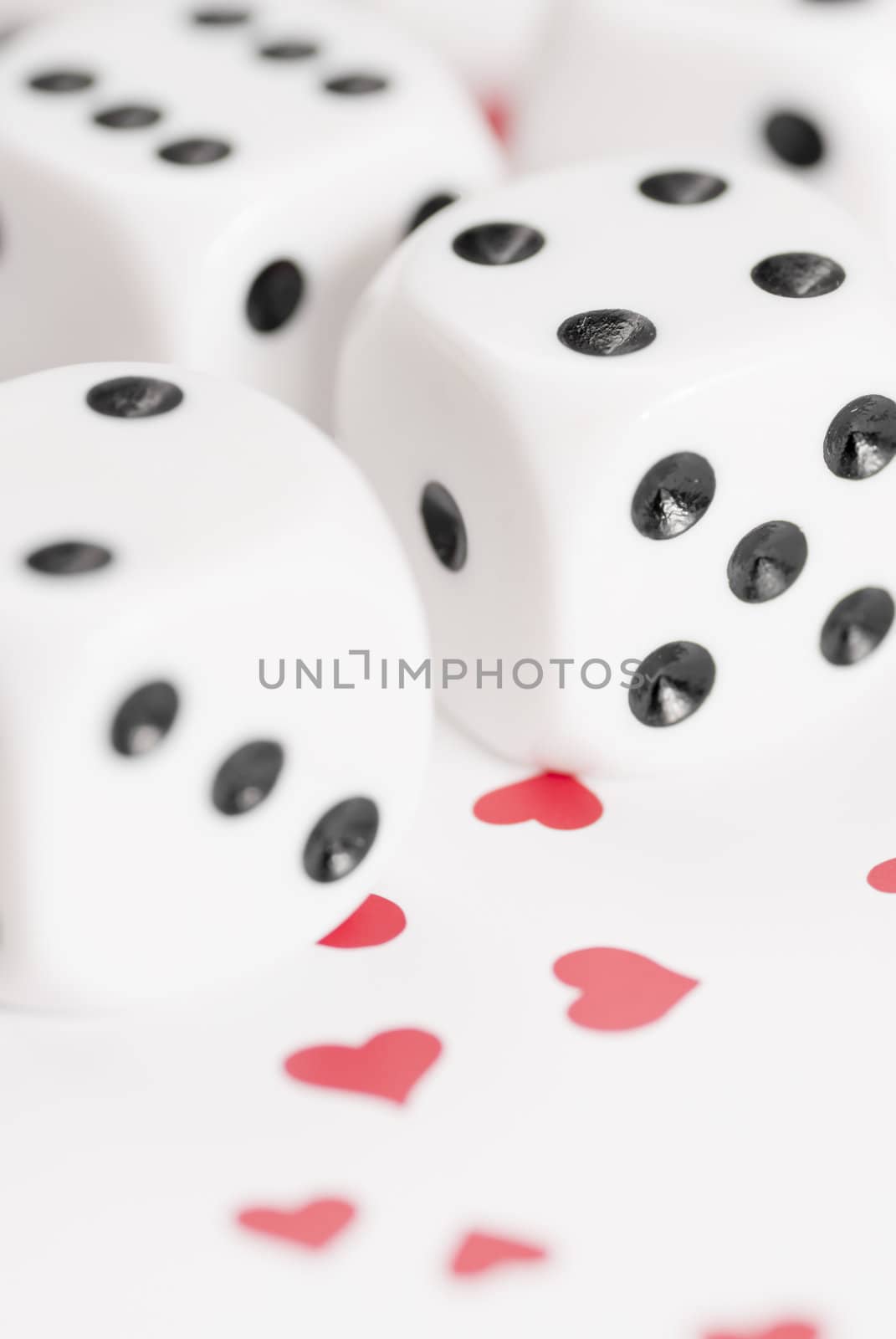 Macro image of dice on love heart background.