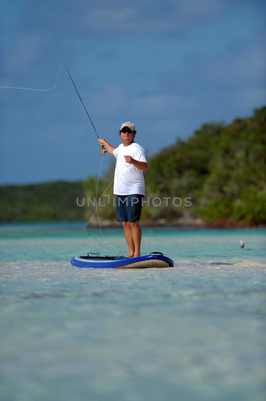Man fly fishing on a paddle board by ftlaudgirl