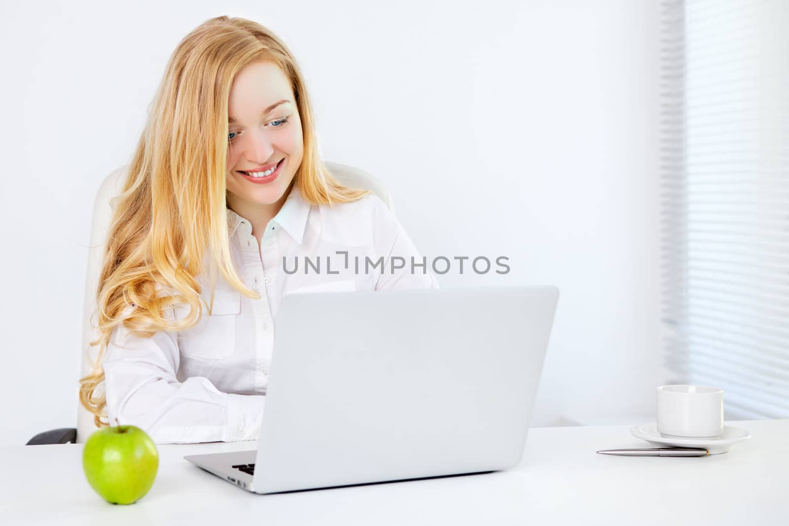 happy business woman with laptop in office