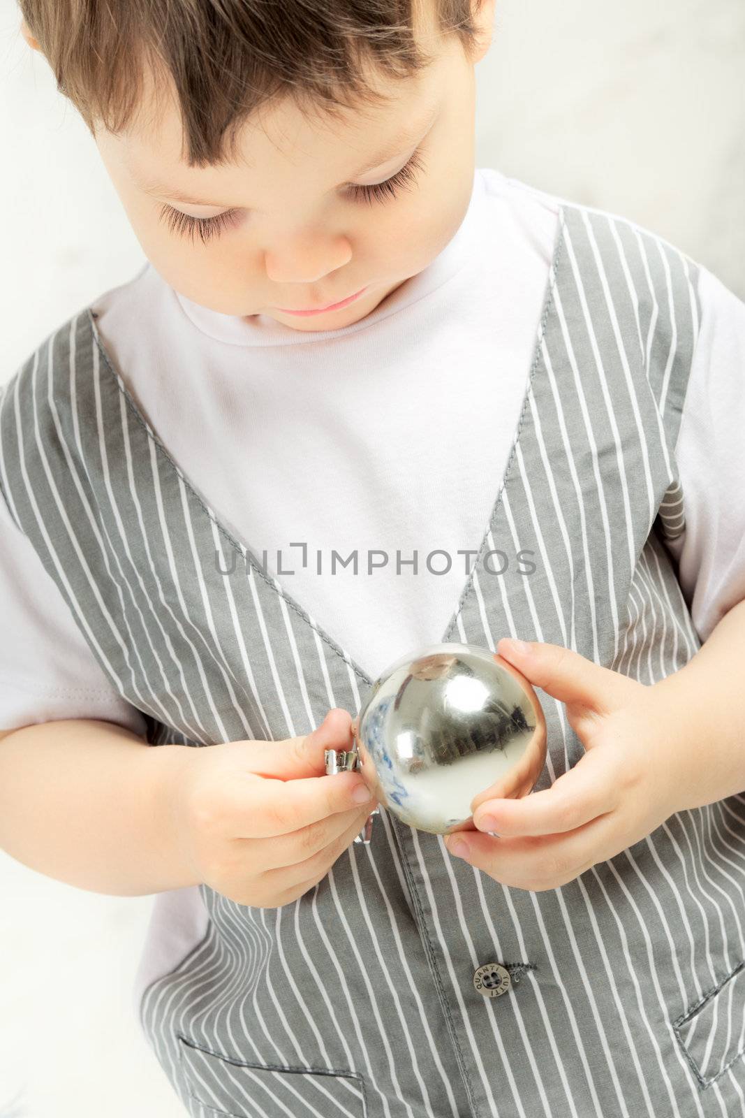 beautiful happy small kid decorate christmas tree