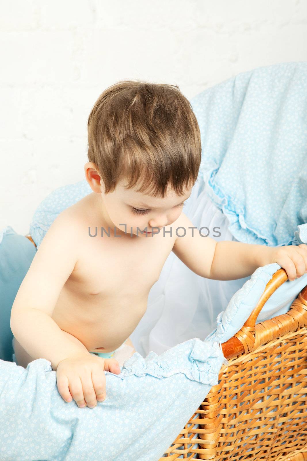 funny boy in cradle, happy and smiling