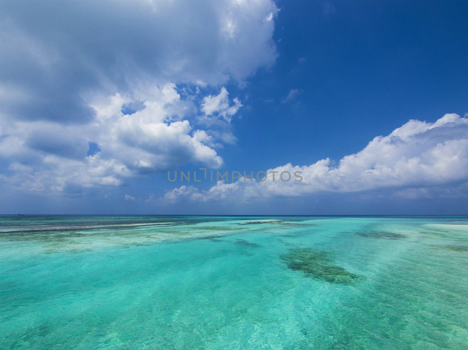 Tropical aquamarine sea and clouds in paradise