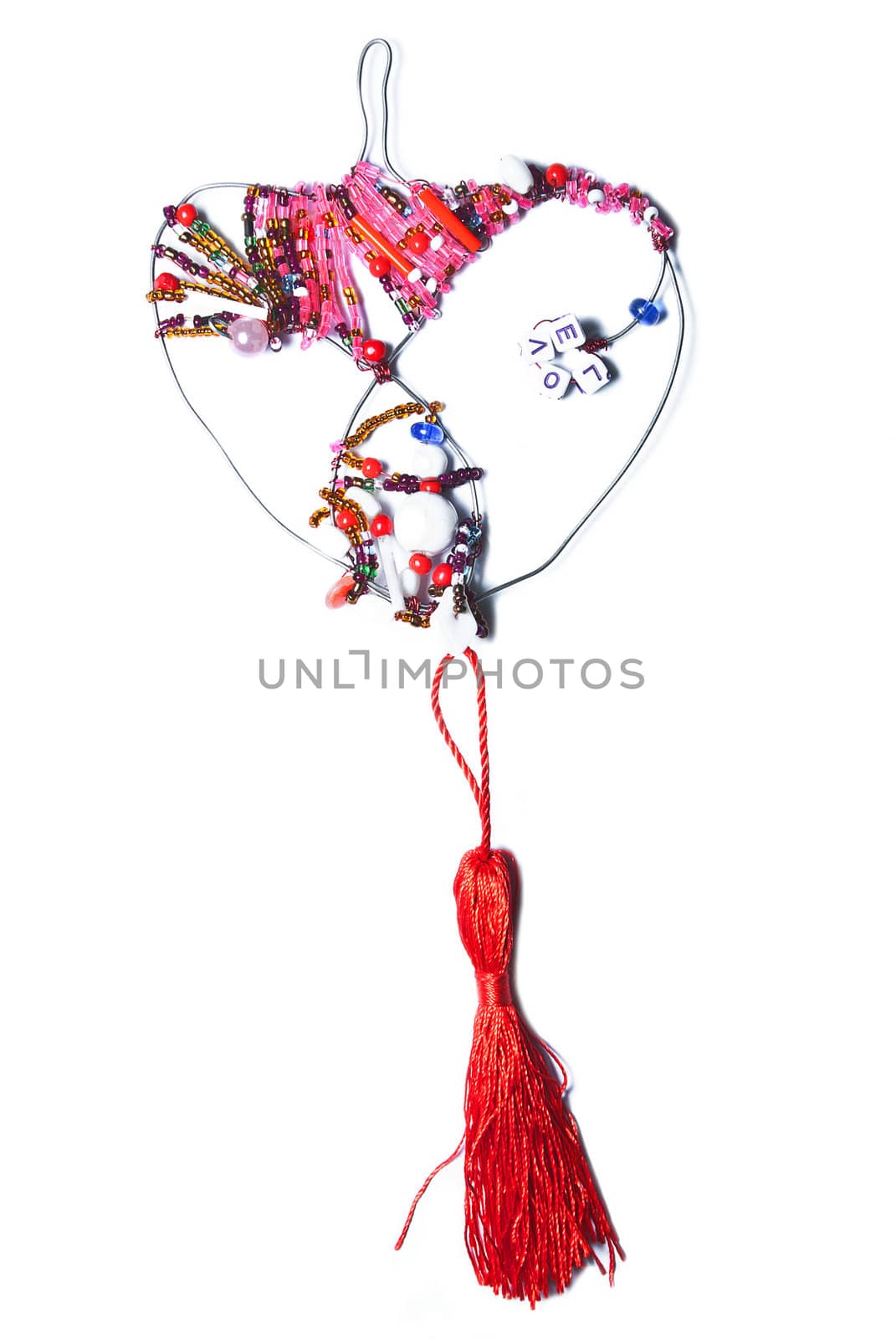 Decorative heart from colorful beads on a white background.