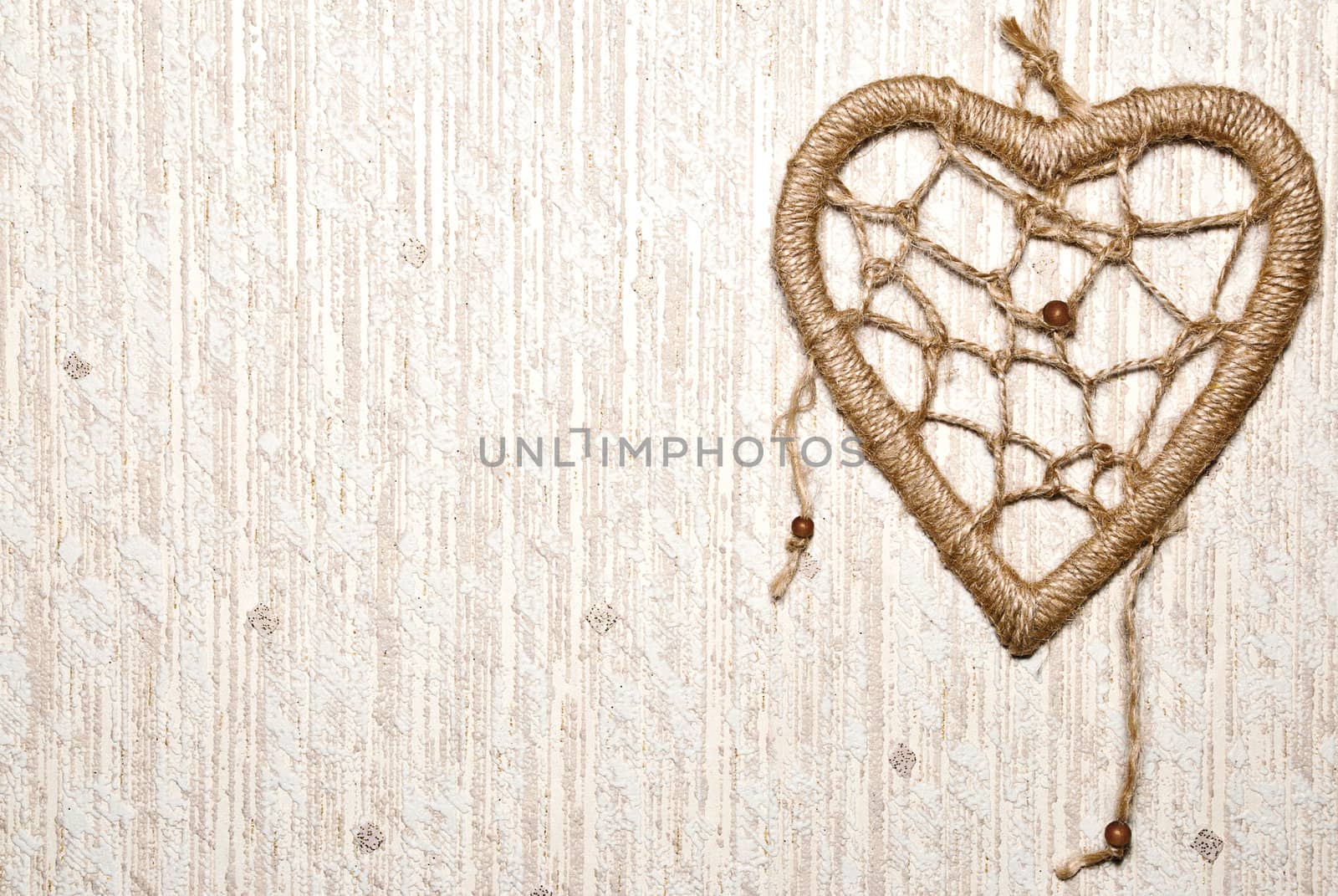 Rope heart on textured background with copy space.