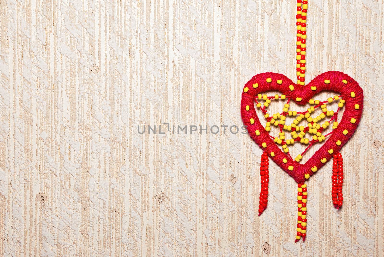 Red heart of colored beads with copy space.