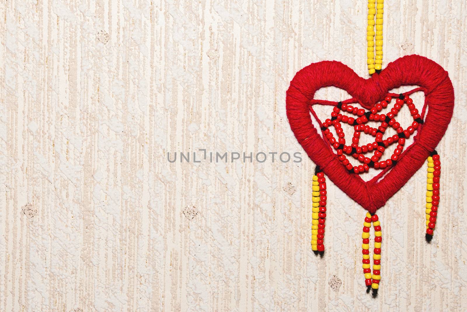 Red heart of colored beads with copy space.