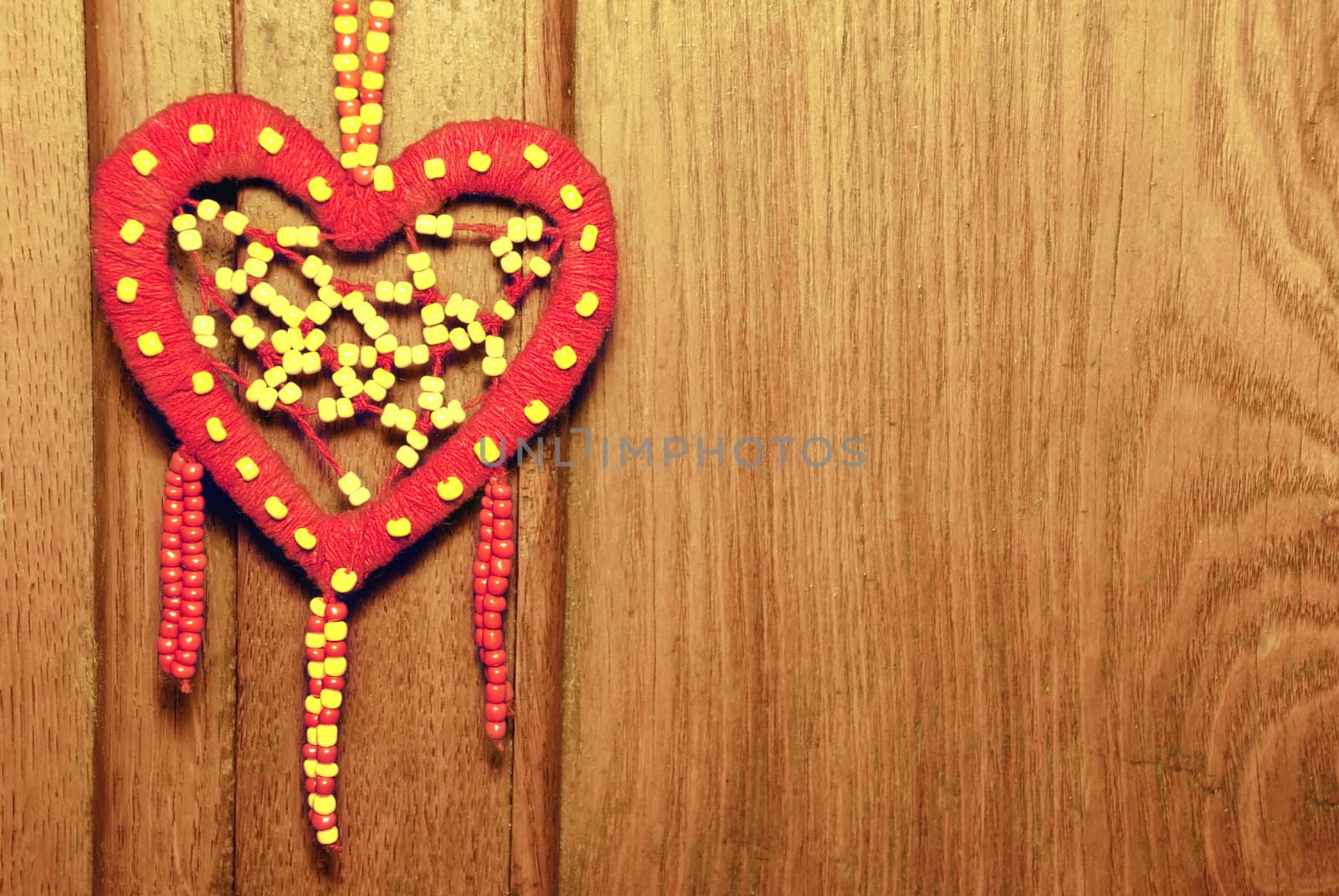 Red heart on the old wood background.