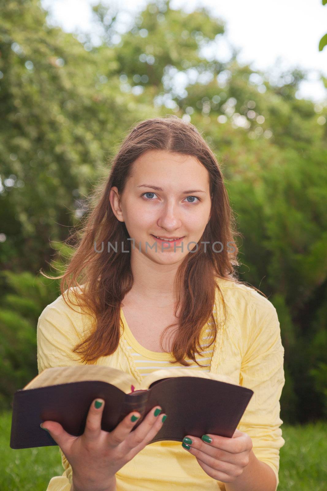 Teen girl reading book by AndreyKr