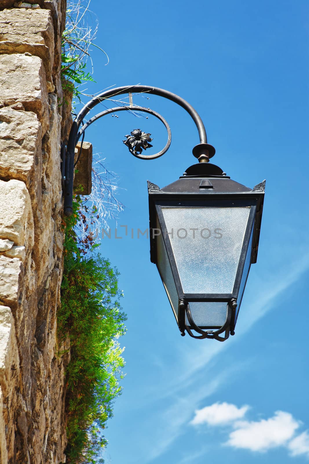 antique street lamp on a wall at day