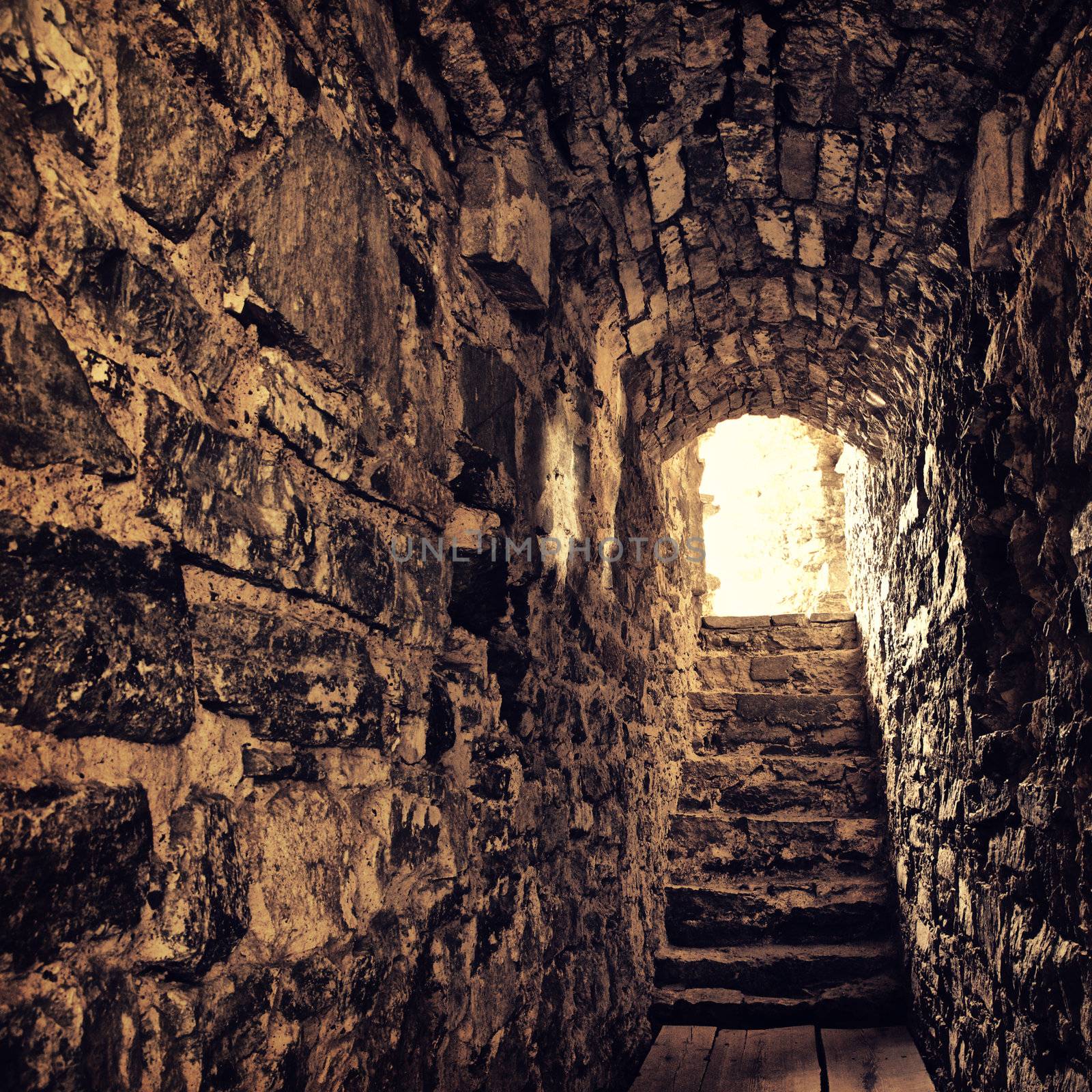 long stone corridor with stairway in ancient castle