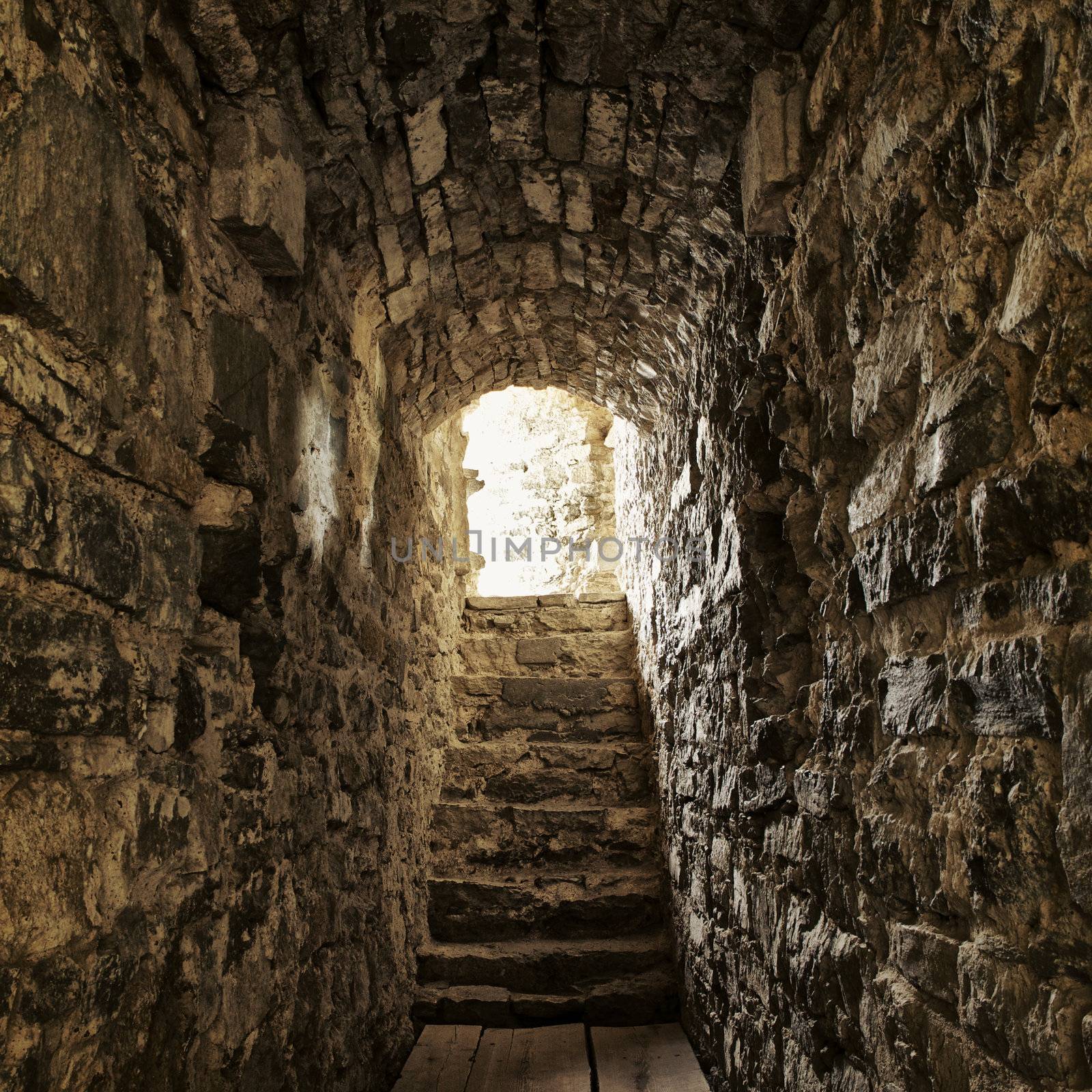 long stone corridor with stairway in ancient castle