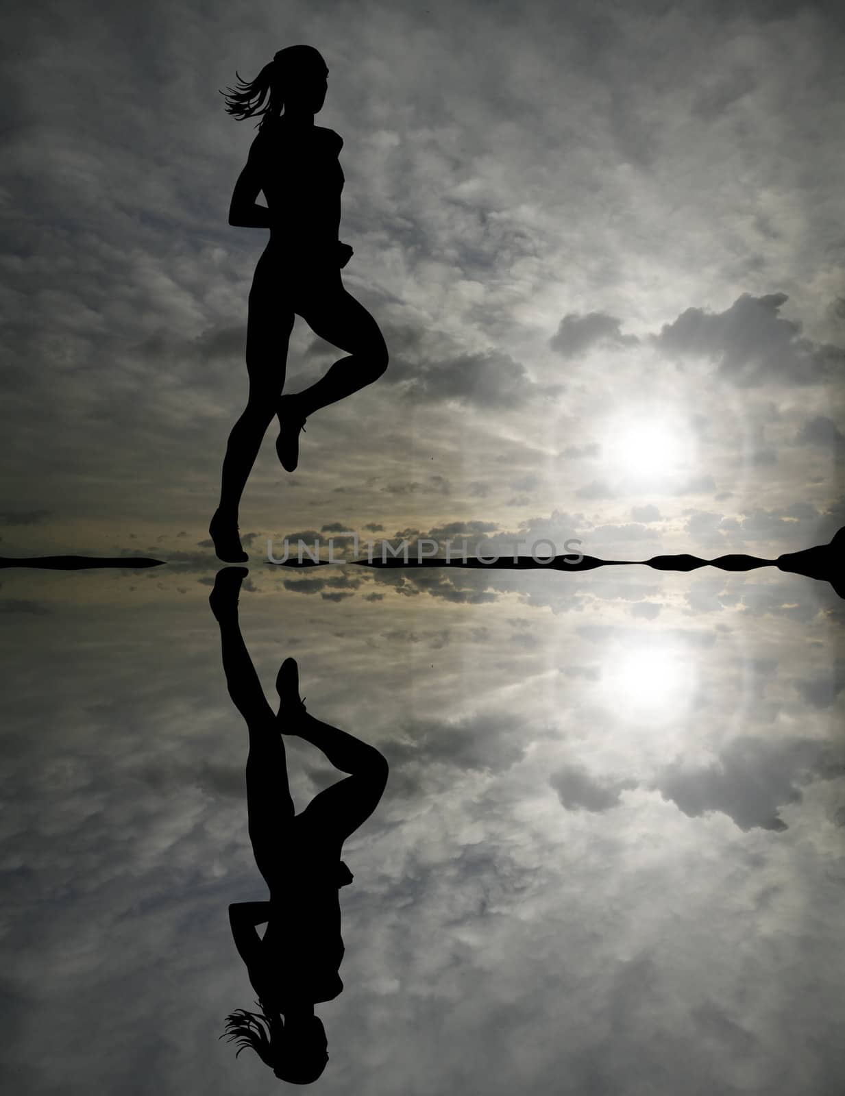Female runner silhouette against the sunset 