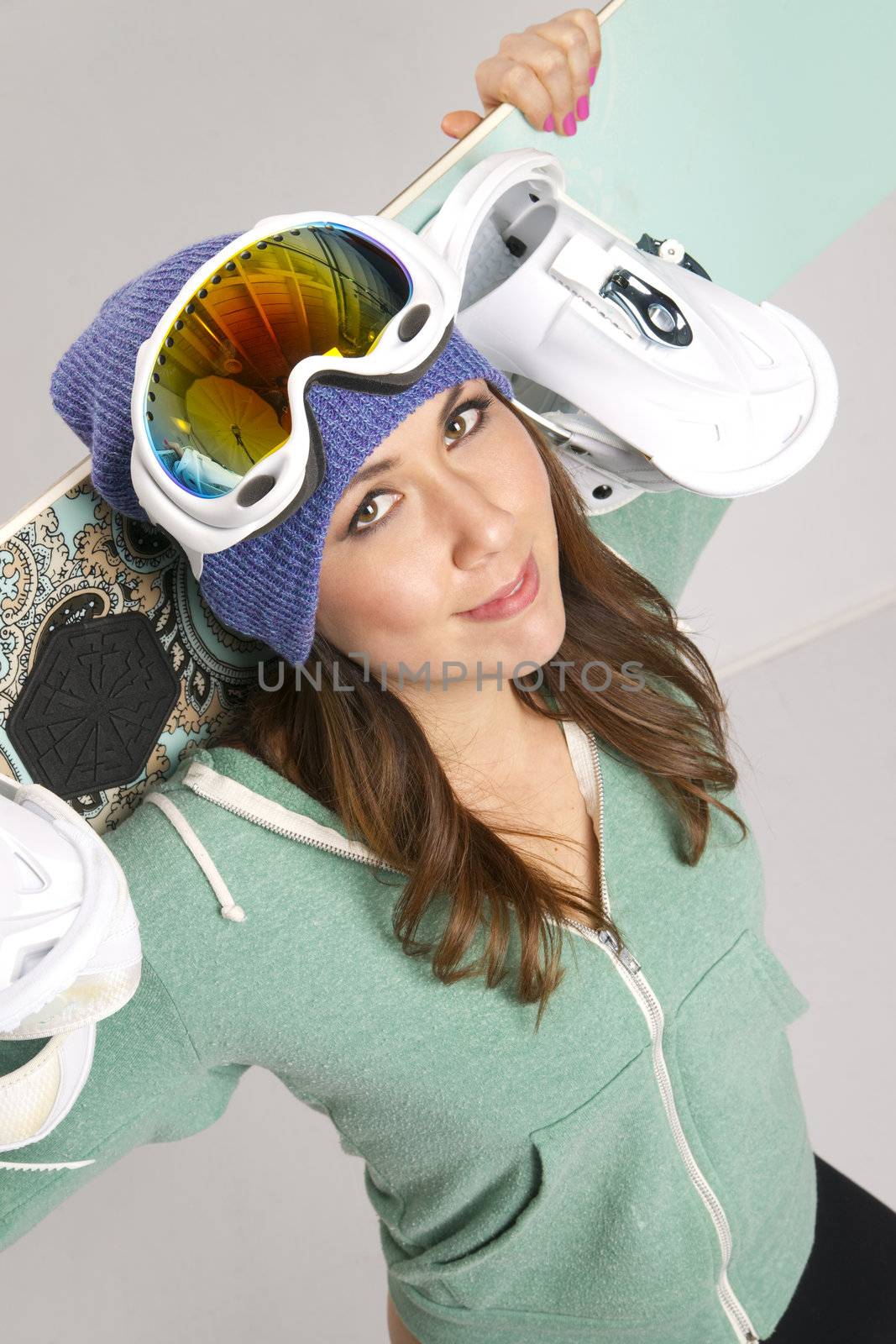 Snowboard and Fun Loving Smiling Female in Teal with all her gear