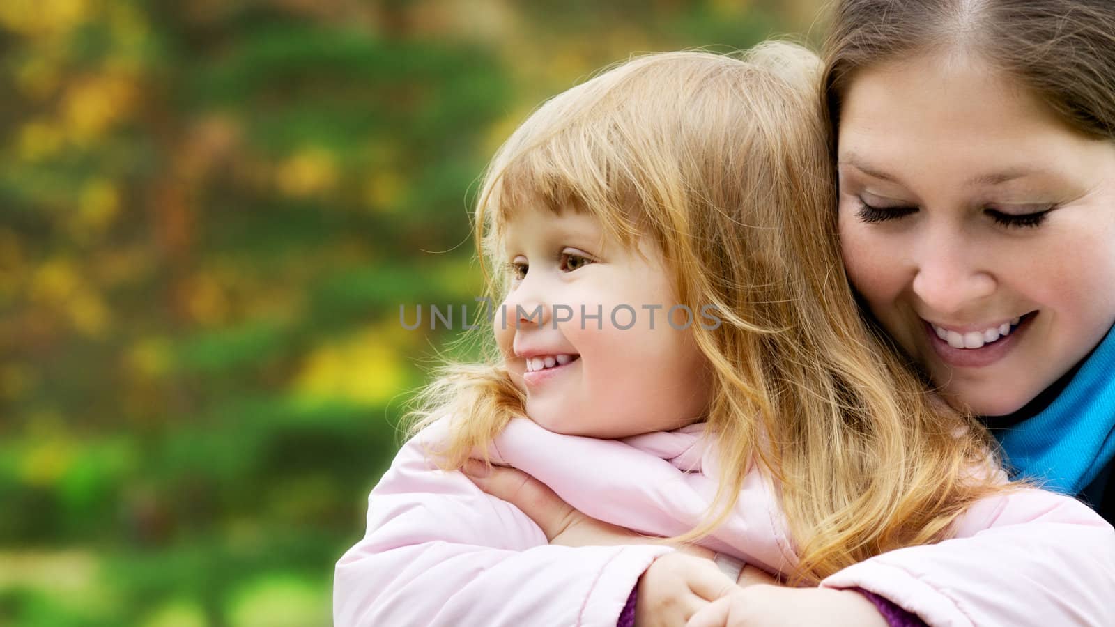 beautiful little girl and mother in autumn park