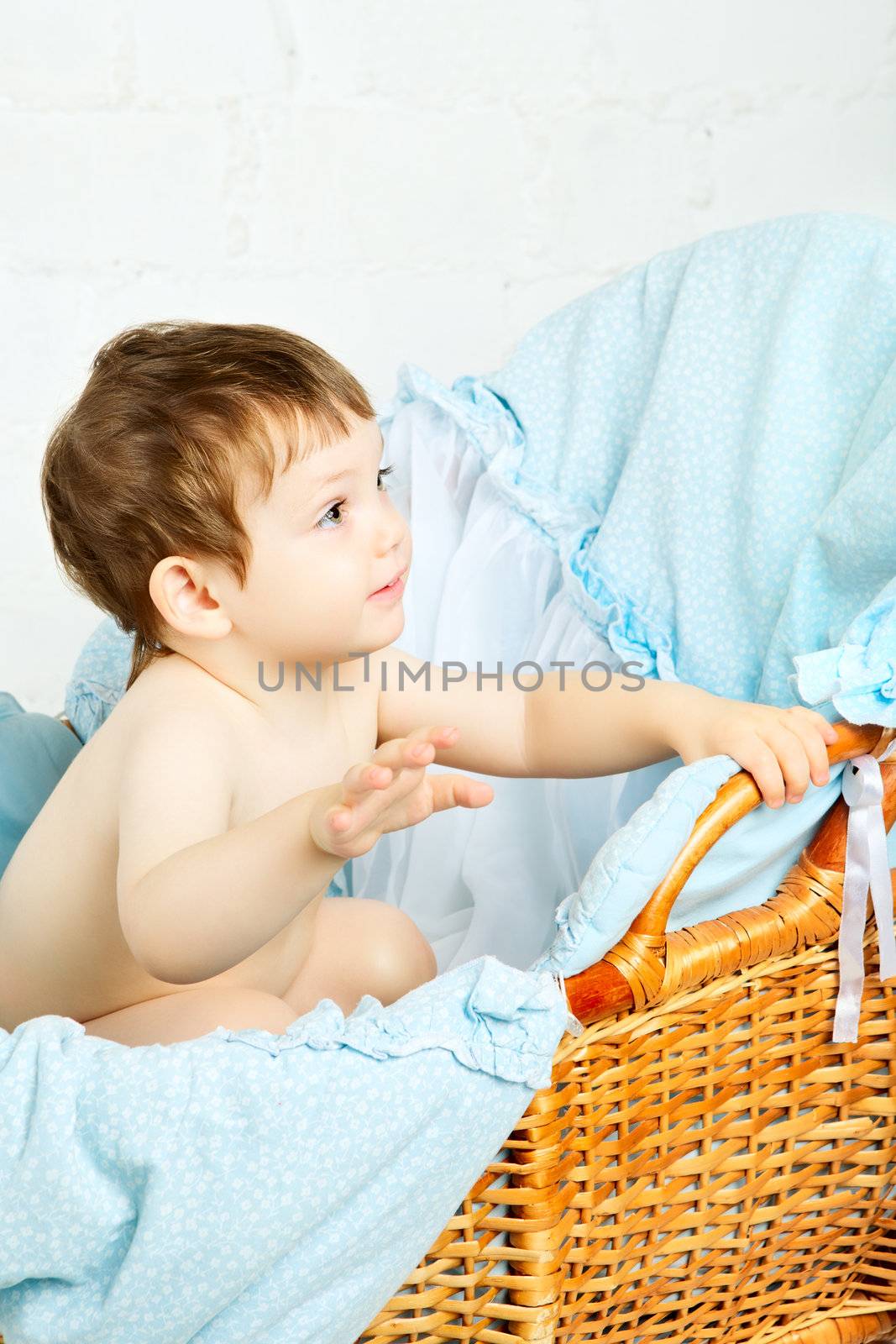 funny boy in cradle, happy and smiling