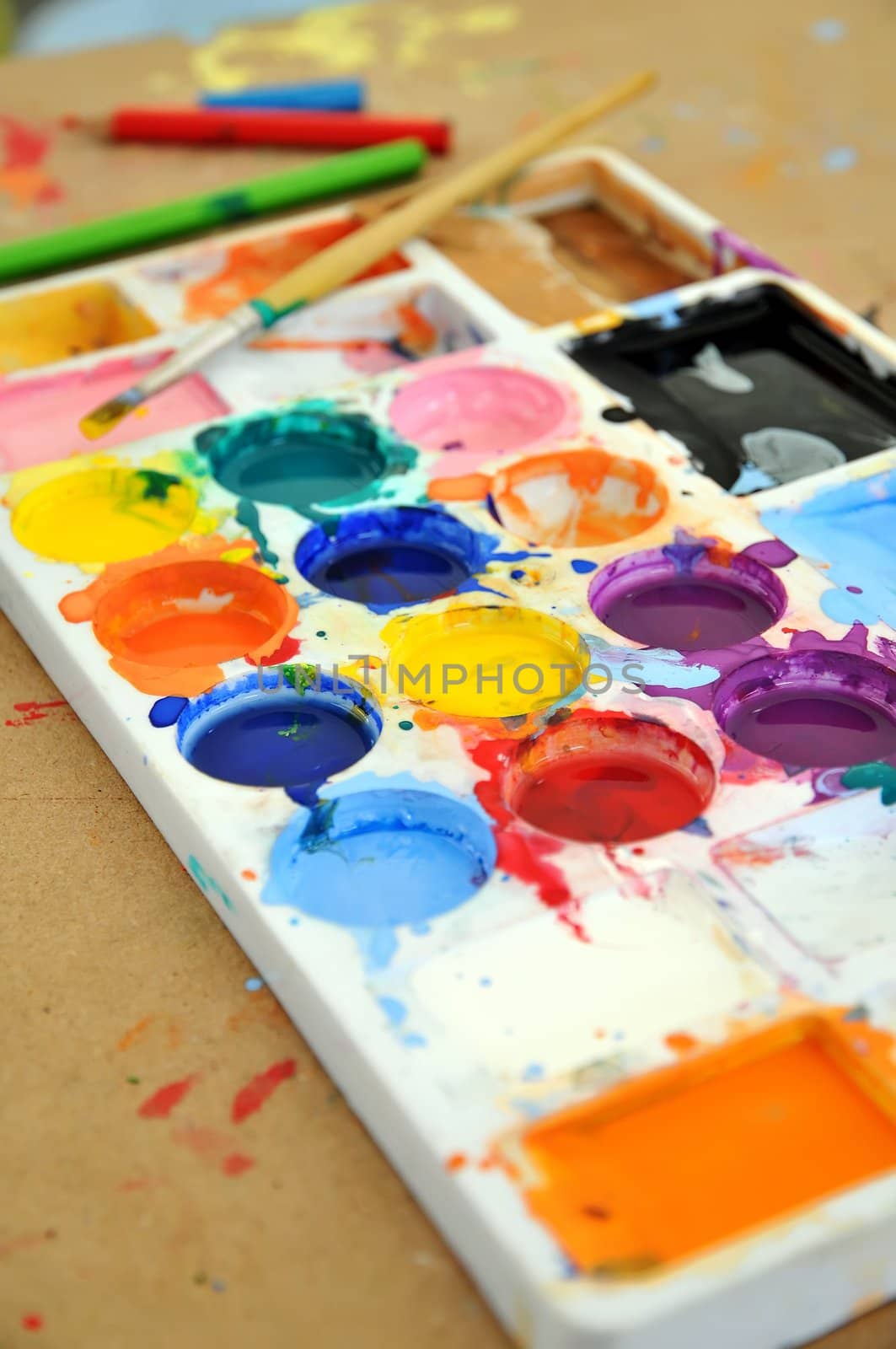 watercolor paint tray with brush