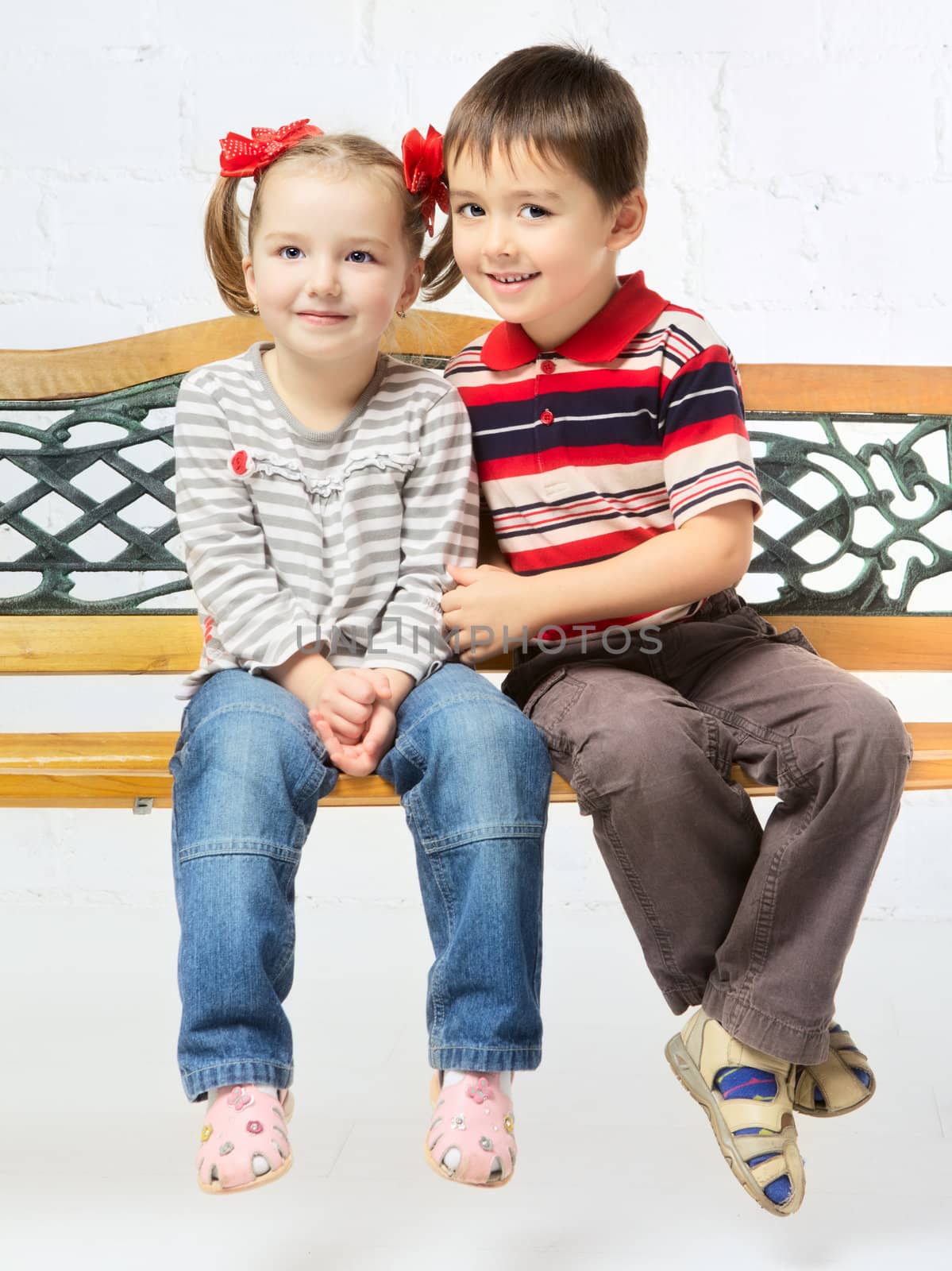 beautiful girl and boy sitting on bench