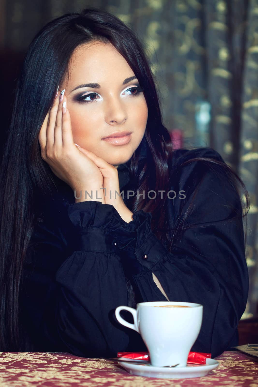 a close up portrait of a brunette drinking coffee