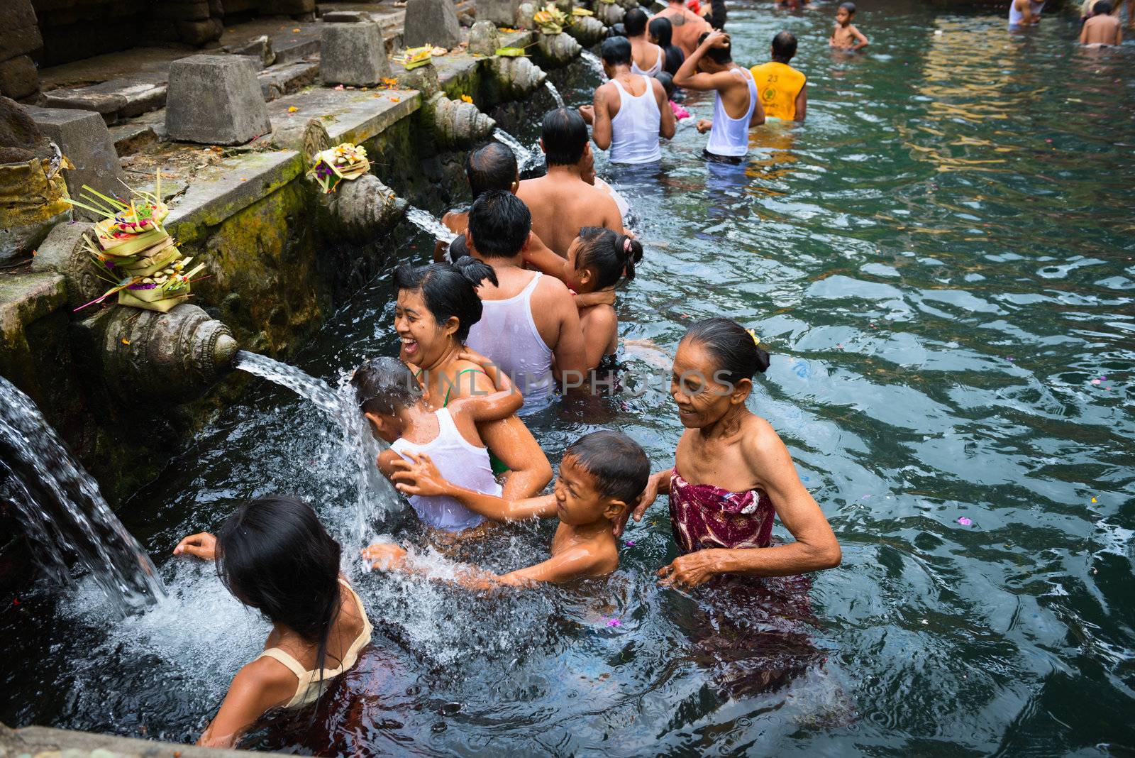 TIRTA EMPUL, INDONESIA - SEP 21: Bali prayers take a bath  in the sacred holy spring water on Sep 21, 2012 in Tirta Empul, Bali, Indonesia. It is famous place for purification of Bali people