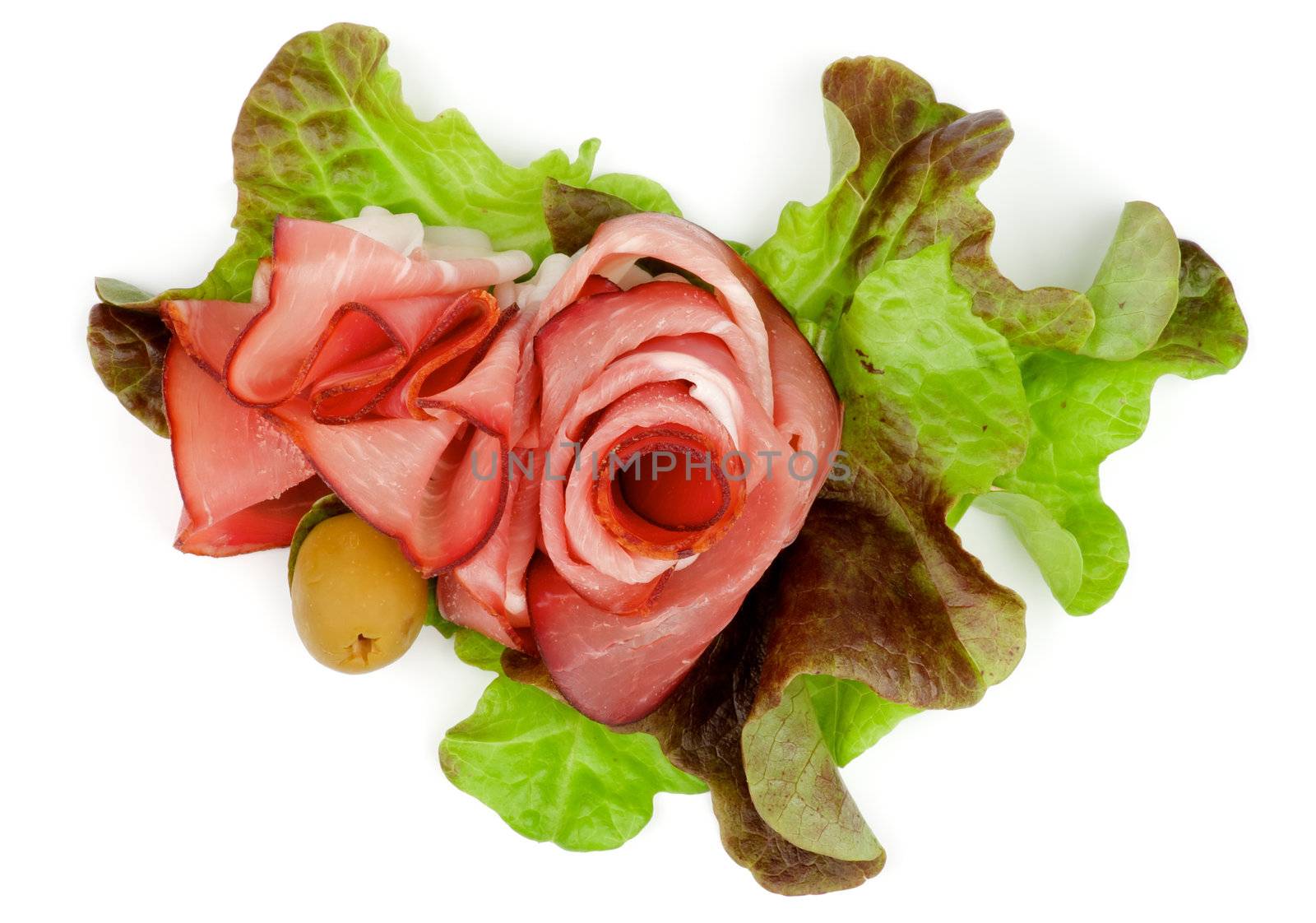 Arrangement of Prosciutto and Greens with Olive closeup on white background. Top View