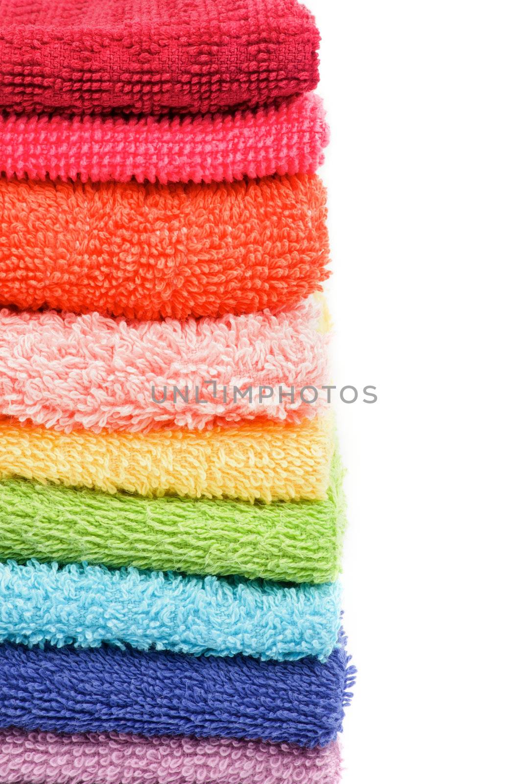 Frame of Stacked Rainbow Colored Towels closeup on white background