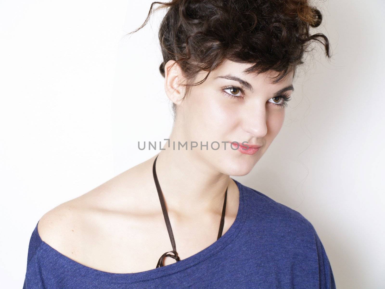 Young woman in blue t-shirt posing by anderm