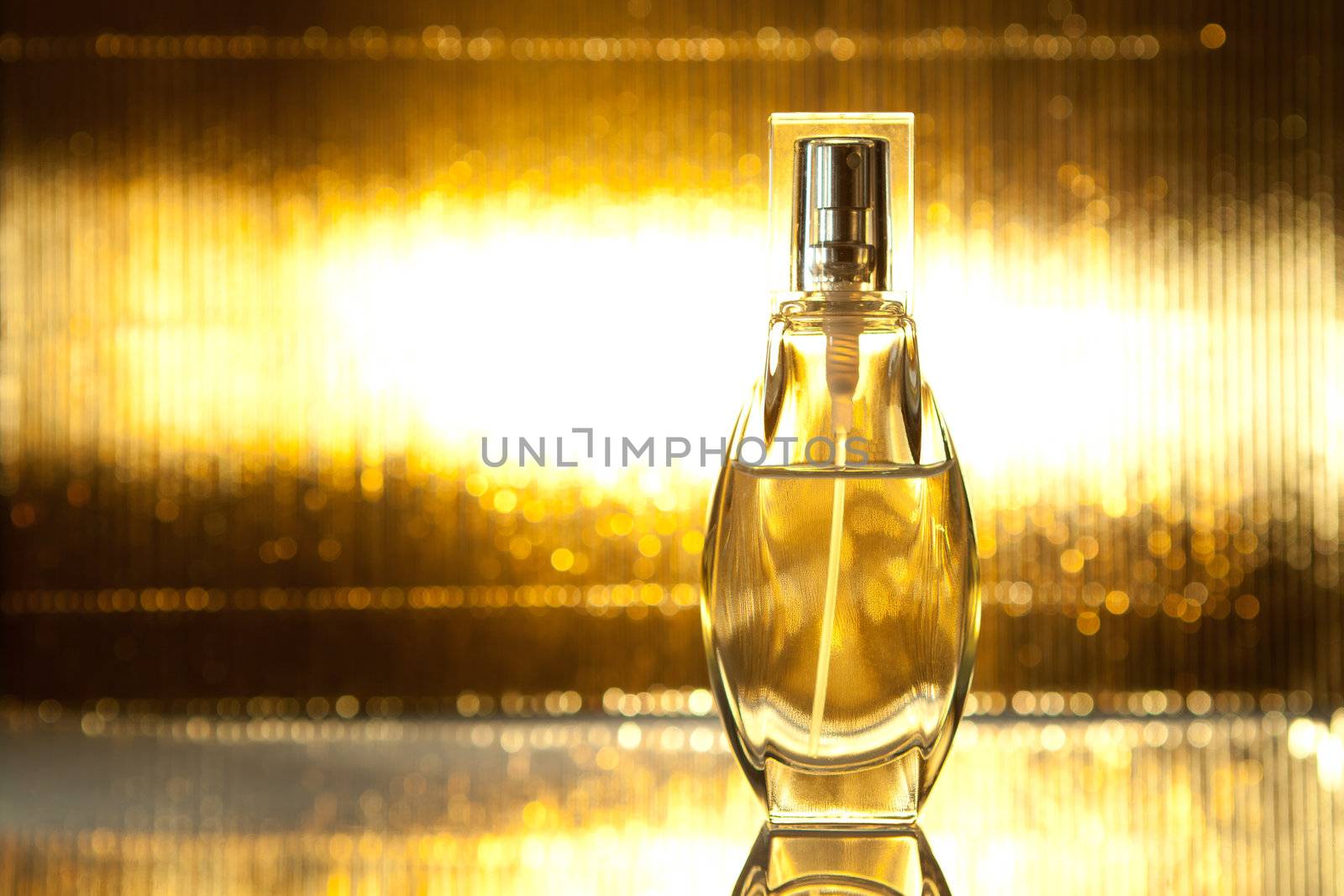 Bottle of perfume on gold background by Speedskater