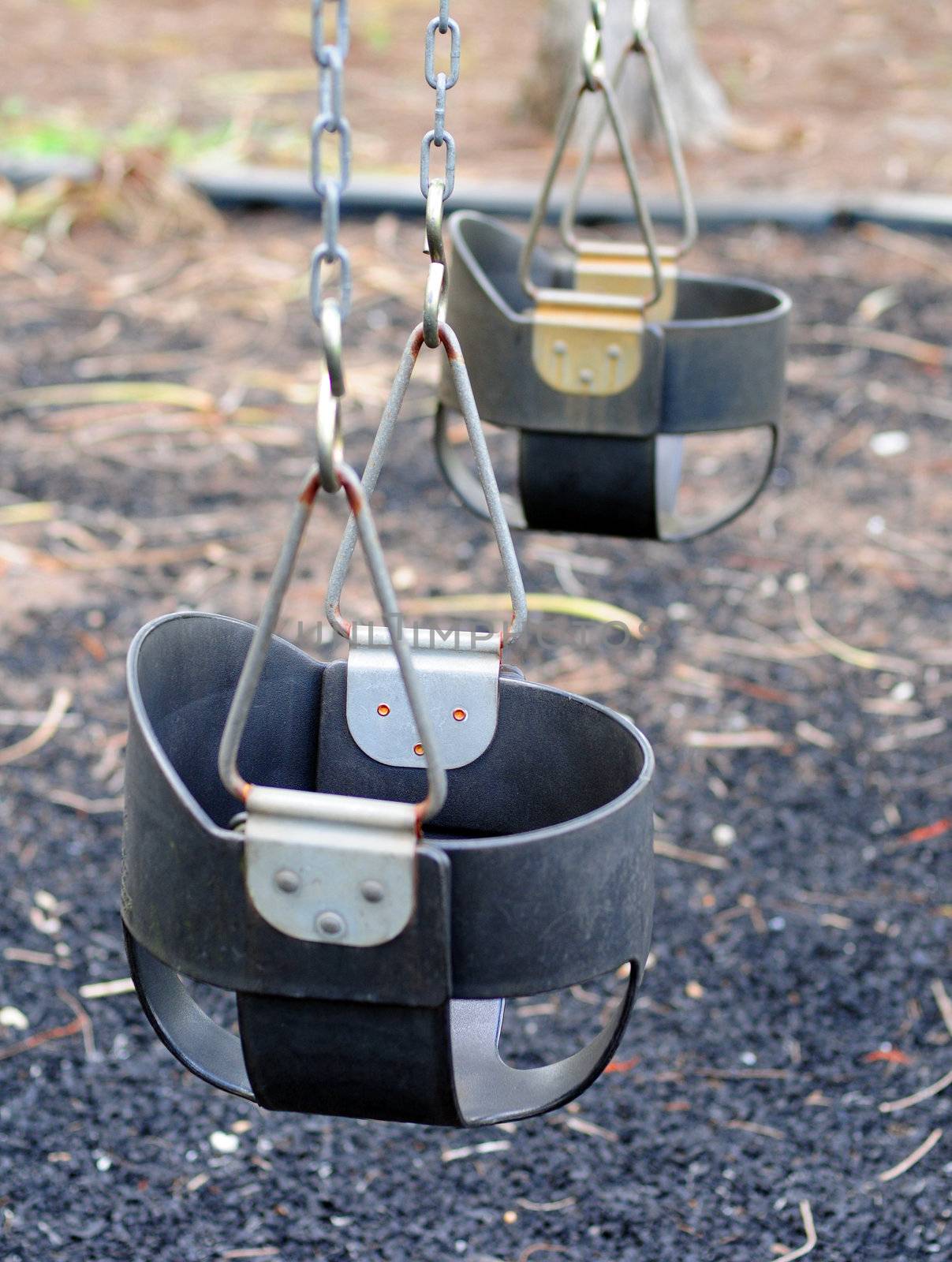 Baby swings at park on a warm summer day