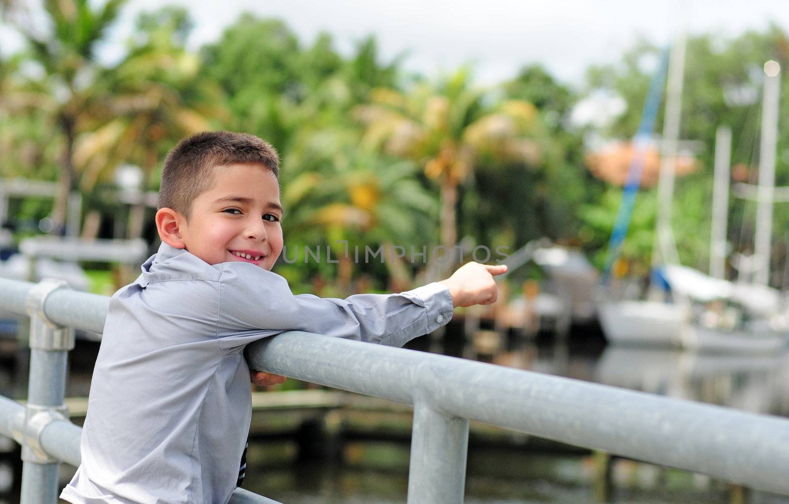 Very happy child pointing at boats by ftlaudgirl