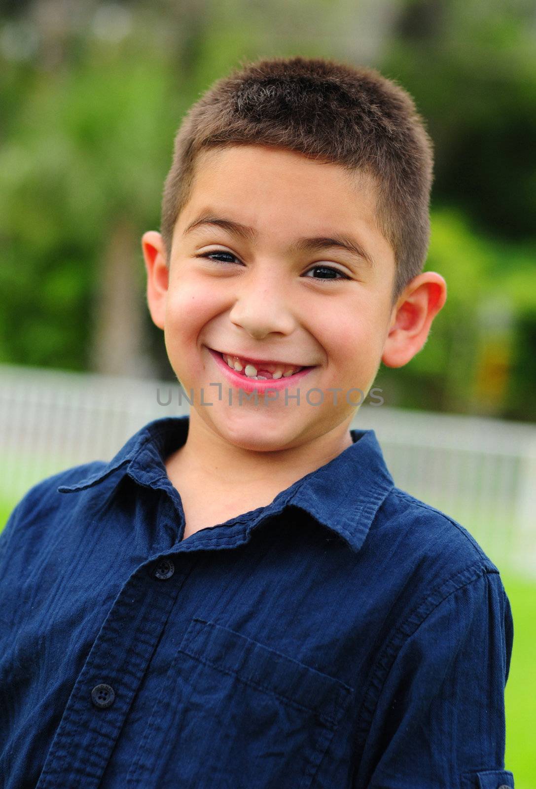 Smiling young hispanic child with missing tooth