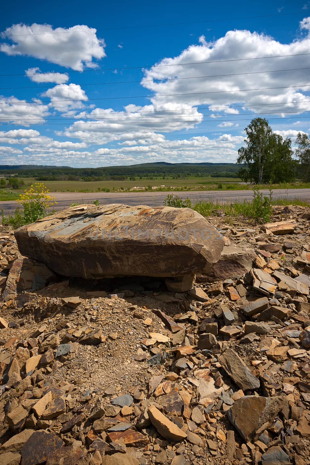 Stones on  road against  blue sky, Russia. Beautiful landscape.