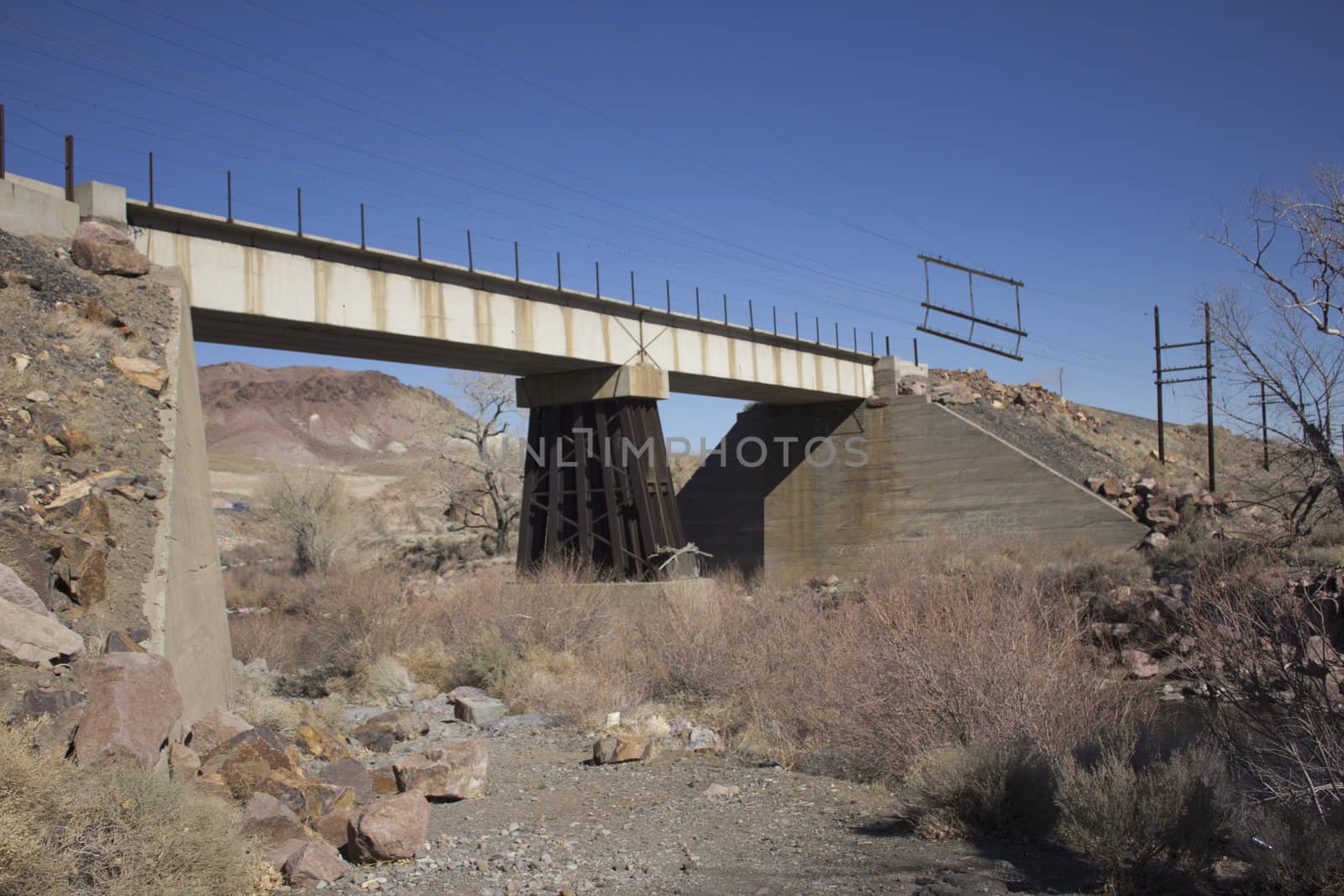 An old train bridge crossing teh truckee river in western nevada
