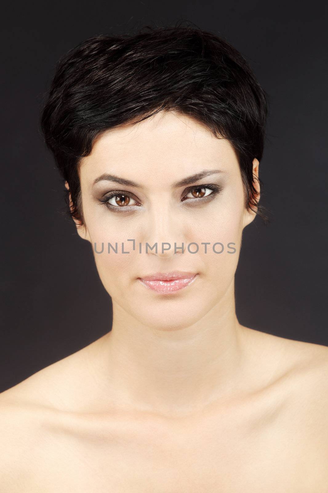 beautiful girl with short black hair, against black background