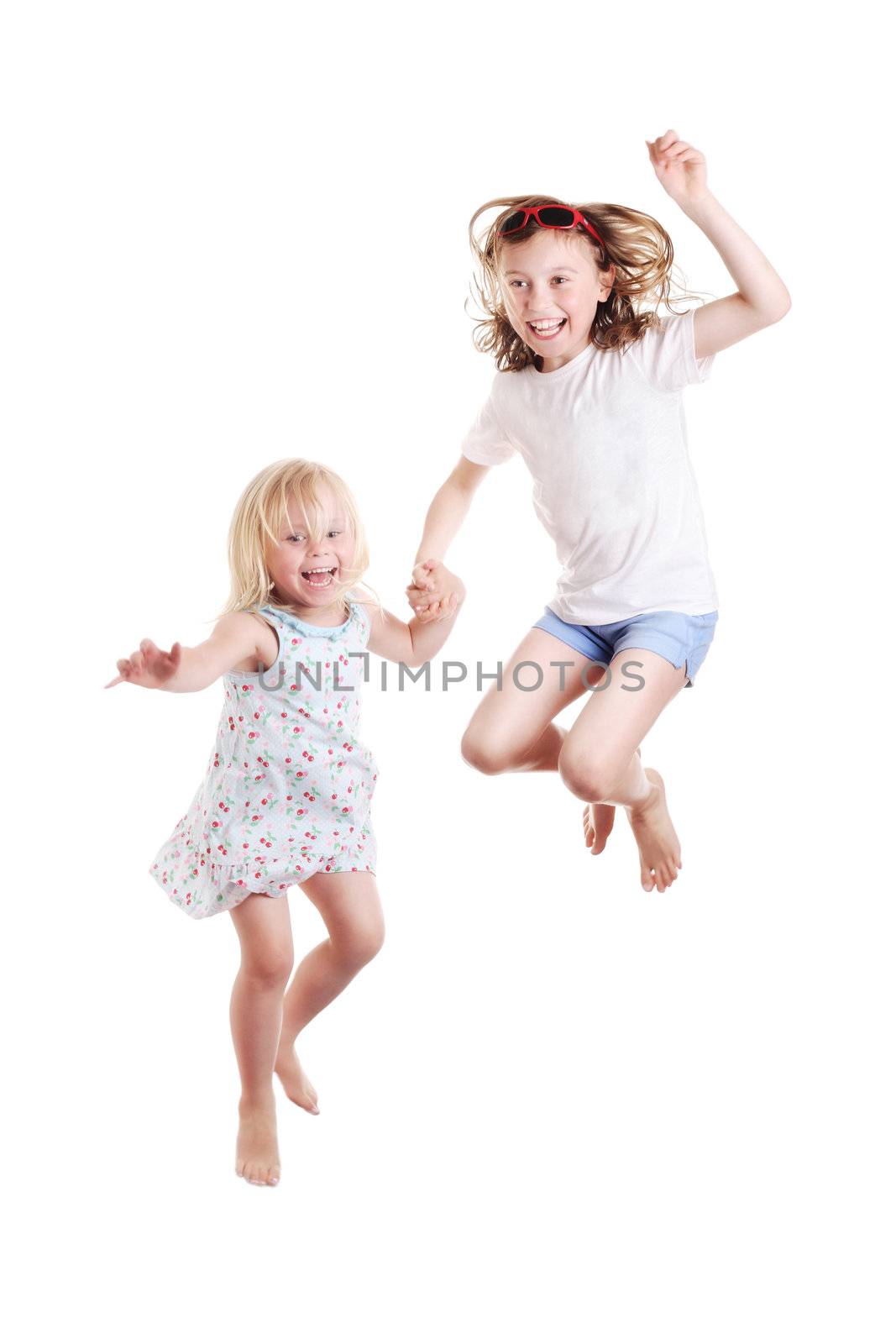 cute little girls jumping on white background